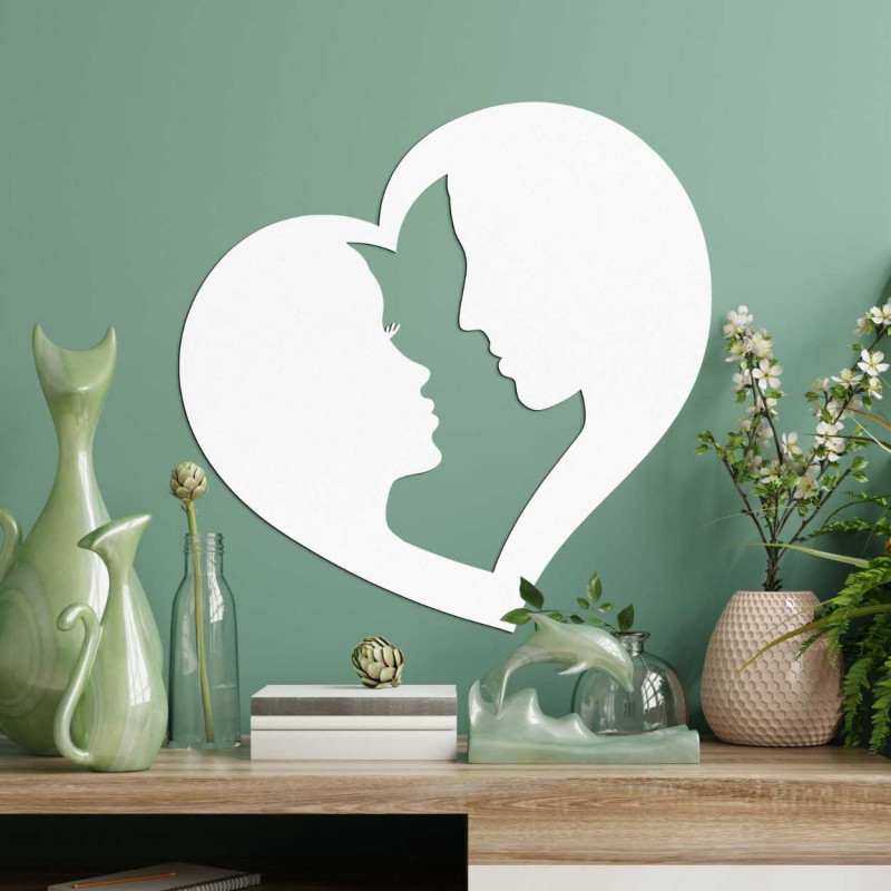 Eine herzförmige Dekoration, bei der die Konturen zweier Gesichter miteinander verbunden sind.